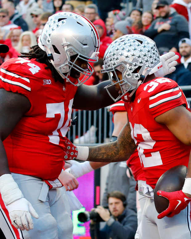 Nov 18, 2023; Columbus, Ohio, USA; Ohio State Buckeyes running back TreVeyon Henderson (32) celebrates his touchdown run with offensive lineman Donovan Jackson (74) during the first quarter against the Minnesota Golden Gophers at Ohio Stadium. Mandatory Credit: Joseph Maiorana-USA TODAY Sports