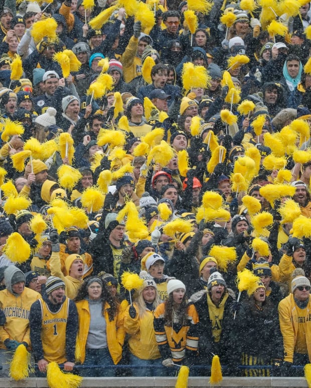 Michigan fans cheer for the Wolverines against Ohio State during the first half at Michigan Stadium in Ann Arbor on Saturday, Nov. 27, 2021.