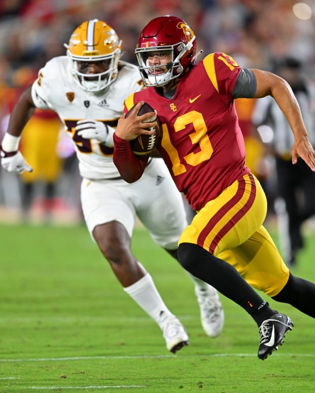 Oct 1, 2022; Los Angeles, California, USA; USC Trojans quarterback Caleb Williams (13) is chased down by Arizona State Sun Devils defensive lineman B.J. Green II (35) as he runs for a first down in the second half at United Airlines Field at the Los Angeles Memorial Coliseum.