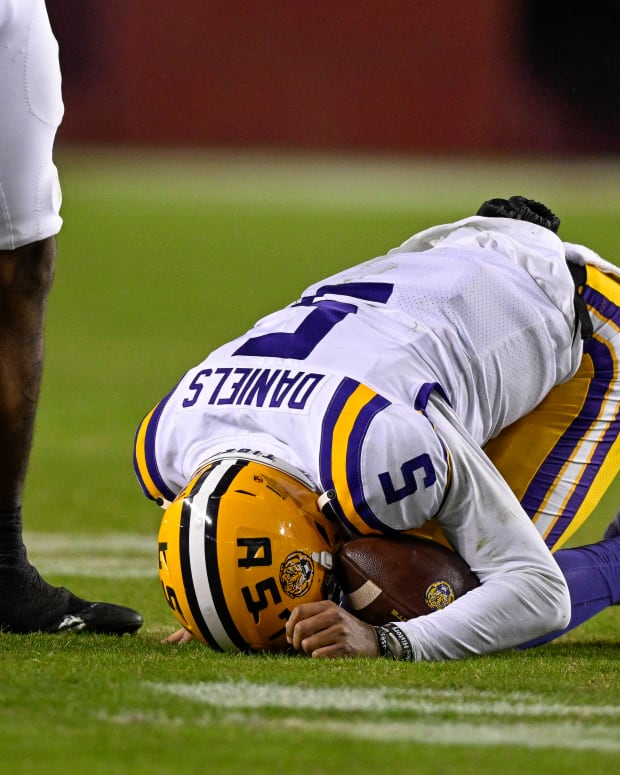 Nov 26, 2022; College Station, Texas, USA; LSU Tigers quarterback Jayden Daniels (5) is injured on a play against the Texas A&M Aggies during the second half at Kyle Field.