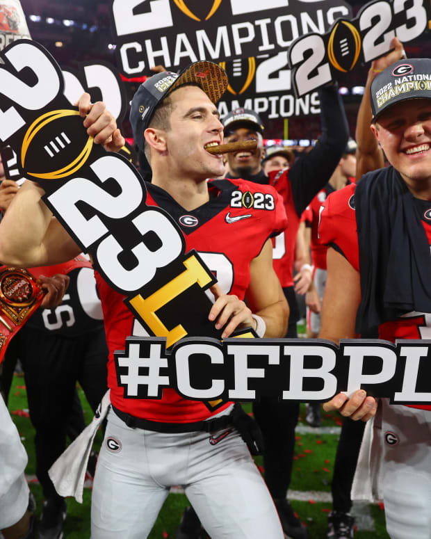 Jan 9, 2023; Inglewood, CA, USA; Georgia Bulldogs offensive lineman Broderick Jones (59) and quarterback Stetson Bennett (13) and long snapper Payne Walker (right) celebrate after winning the CFP national championship game against the TCU Horned Frogs at SoFi Stadium.