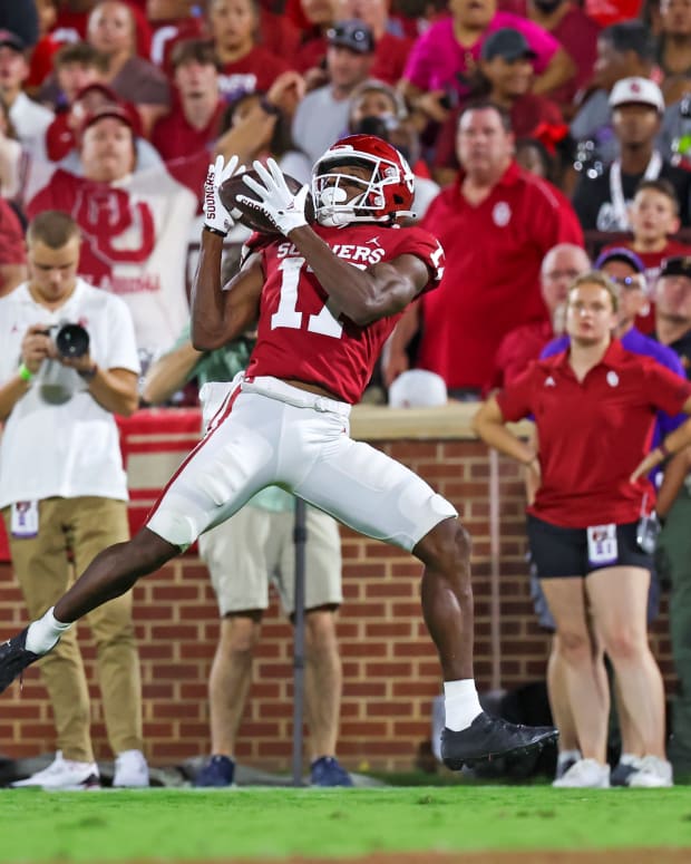Sep 24, 2022; Norman, Oklahoma, USA; Oklahoma Sooners wide receiver Marvin Mims (17) catches a touchdown pass past Kansas State Wildcats cornerback Omar Daniels (4) during the first half at Gaylord Family-Oklahoma Memorial Stadium.