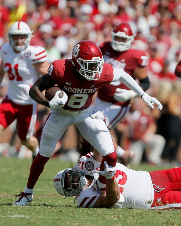 Oklahoma's Michael Woods II (8) tries to get away from Nebraska's JoJo Domann (13) during a 23-16 win on Sept. 18 in Norman.