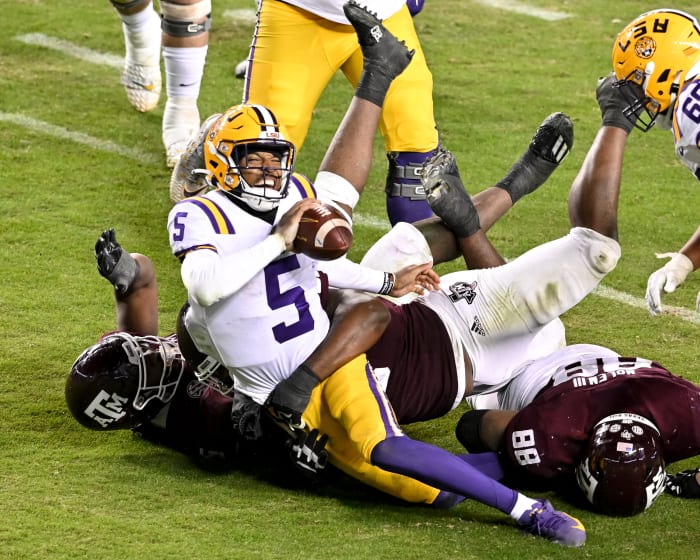 Nov 26, 2022; College Station, Texas, USA; Texas A&M Aggies defensive lineman Shemar Turner (5) and defensive lineman McKinnley Jackson (35) sack LSU Tigers quarterback Jayden Daniels (5) during the fourth quarter at Kyle Field.