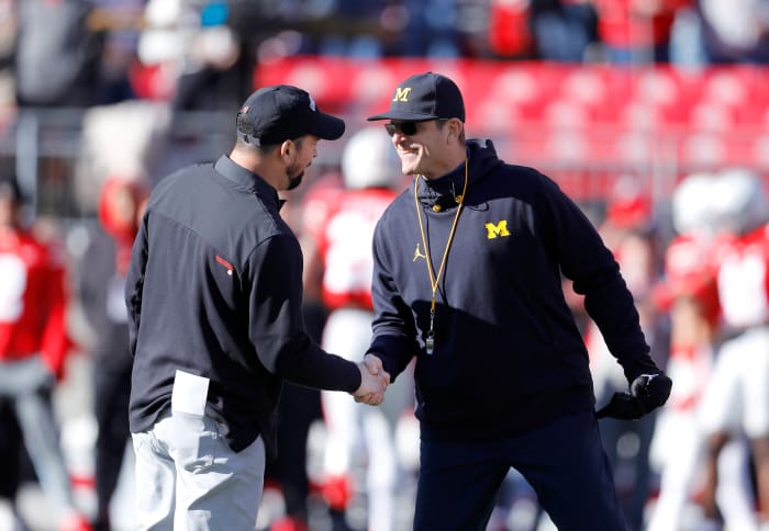 Nov 26, 2022; Columbus, Ohio, USA; Michigan Wolverines head coach Jim Harbaugh (right) and Ohio State Buckeyes head coach Ryan Day (left) shake hands before the game at Ohio Stadium.
