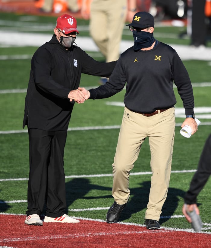 Nov 7, 2020; Bloomington, Indiana, USA; Indiana Hoosiers head coach Tom Allen shakes the hand of Michigan Wolverines head coach Jim Harbaugh after the game at Memorial Stadium. The Indiana Hoosiers defeated the Michigan Wolverines 38 to 21