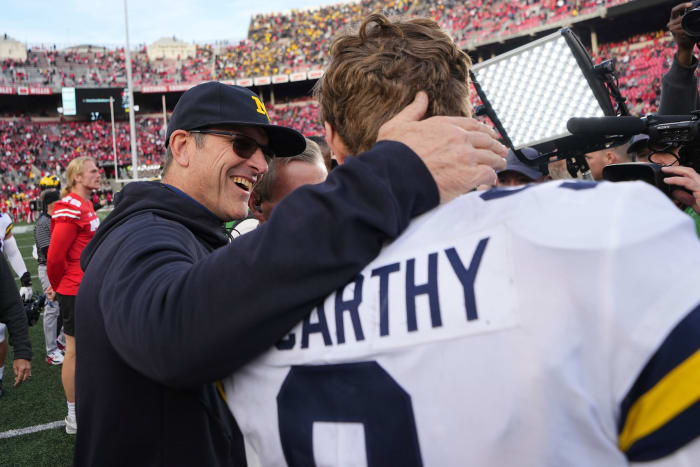 Nov 26, 2022; Columbus, Ohio, USA; Michigan Wolverines head coach Jim Harbaugh hugs Michigan Wolverines quarterback J.J. McCarthy (9) following their 45-23 win over the Ohio State Buckeyes in the NCAA football game at Ohio Stadium.