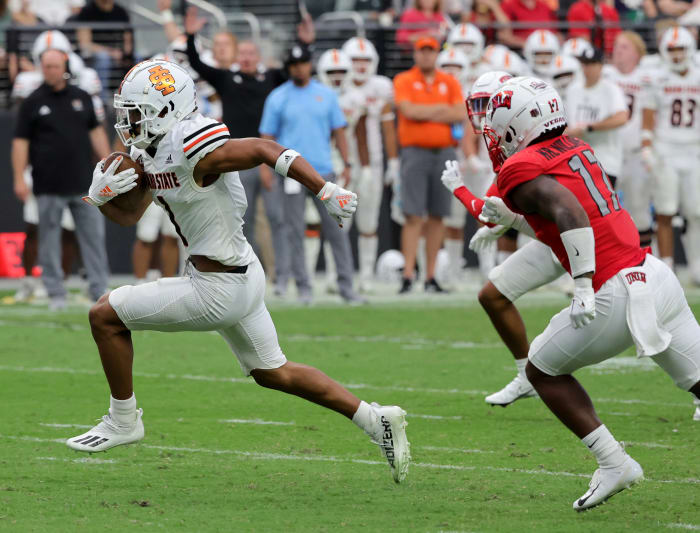 LAS VEGAS, NEVADA - AUGUST 27: Wide receiver Xavier Guillory #1 of the Idaho State Bengals scores a touchdown on a 19-yard pass play ahead of defensive back Kris Williams #17 of the UNLV Rebels during their game at Allegiant Stadium on August 27, 2022 in Las Vegas, Nevada. The Rebels defeated the Bengals 52-21.