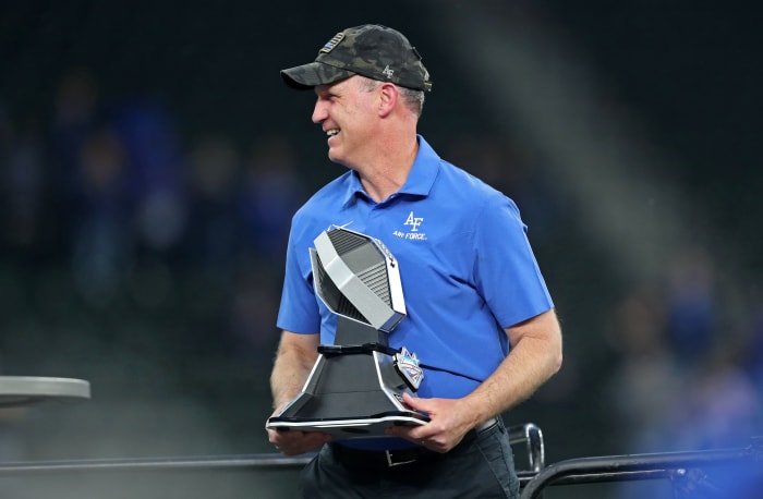 Nov 5, 2022; Arlington, Texas, USA; Air Force Falcons head coach Troy Calhoun celebrates with the Commanders Classic trophy after a win against the Army Black Knights at Globe Life Field.