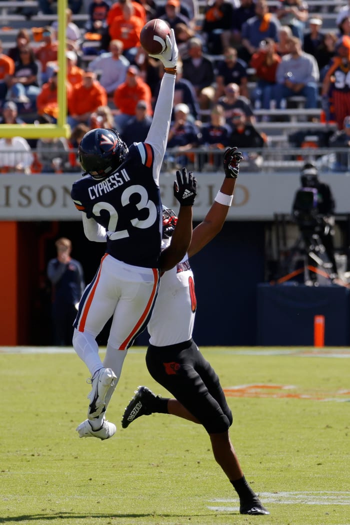 Oct 8, 2022; Charlottesville, Virginia, USA; Virginia Cavaliers cornerback Fentrell Cypress II (23) attempts to intercept a pass intended for Louisville Cardinals wide receiver Tyler Hudson (0) during the first quarter at Scott Stadium.