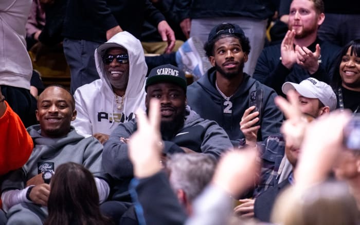 New Colorado football coach Deion Sanders, a NFL Hall of Fame cornerback, and his son and new CU quarterback, Shadeur Sanders, are cheered early in the second half against Colorado State during the Rocky Mountain Showdown at the CU Event Center in Boulder on Thursday Dec. 8, 2022.