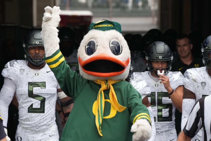 Oct 23, 2021; Pasadena, California, USA; Oregon Ducks mascot Puddles leads players onto the field before the game against the UCLA Bruins Rose Bowl.