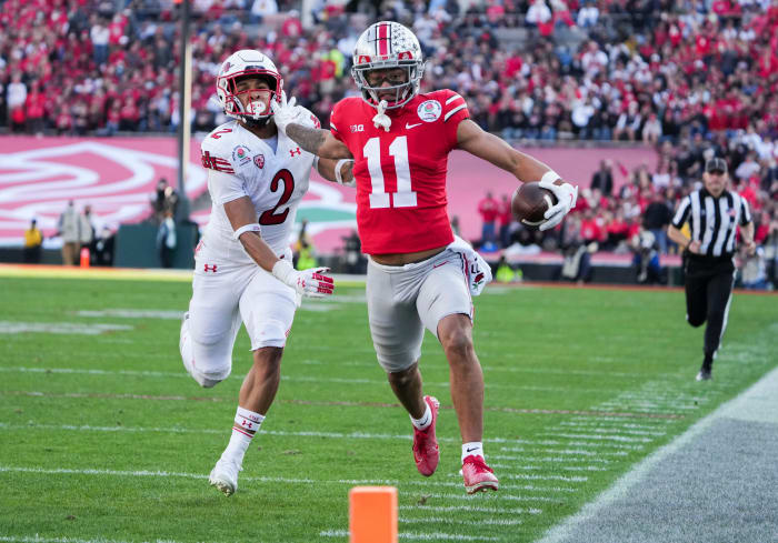 Sat., Jan. 1, 2022; Pasadena, California, USA; Ohio State Buckeyes wide receiver Jaxon Smith-Njigba (11) fends off Utah Utes cornerback Micah Bernard (2) as he races to the end zone for a touchdown during the second quarter of the 108th Rose Bowl Game between the Ohio State Buckeyes and the Utah Utes at the Rose Bow