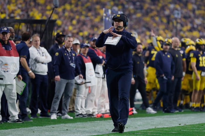 Michigan head coach Jim Harbaugh signals for a timeout in the first quarter against TCU during the Fiesta Bowl on Saturday, Dec. 31 at State Farm Stadium in Glendale, Ariz.