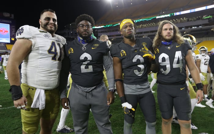 Oct 24, 2020; Pittsburgh, Pennsylvania, USA; Alumni of Pittsburgh Central Catholic High School Notre Dame Fighting Irish defensive lineman Kurt Hinish (41) and Pittsburgh Panthers defensive lineman David Green (2) and defensive back Damar Hamlin (3) and long snapper Cal Adomitis (94) pose for a photo after their game at Heinz Field.