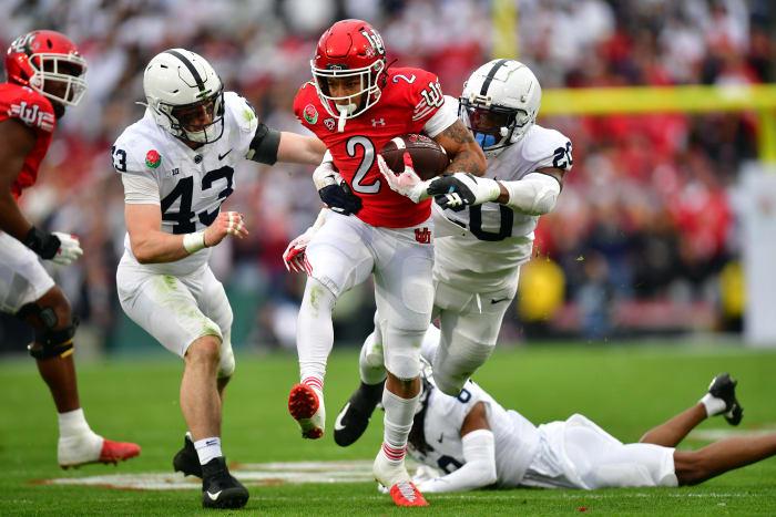 Jan 2, 2023; Pasadena, California, USA; Utah Utes running back Micah Bernard (2) runs against Penn State Nittany Lions linebacker Tyler Elsdon (43) and defensive end Adisa Isaac (20) in the first half in the 109th Rose Bowl game at the Rose Bowl.