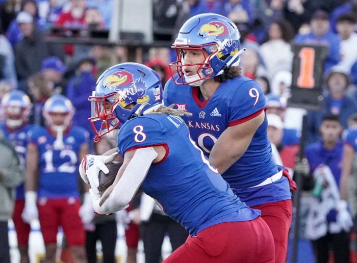 Nov 5, 2022; Lawrence, Kansas, USA; Kansas Jayhawks quarterback Jason Bean (9) hands off to running back Ky Thomas (8) against the Oklahoma State Cowboys during the second half of the game at David Booth Kansas Memorial Stadium.