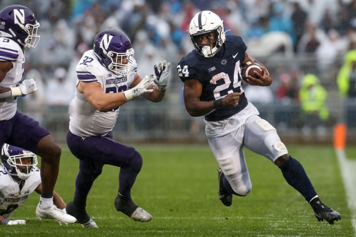 Oct 1, 2022; University Park, Pennsylvania, USA; Penn State Nittany Lions running back Keyvone Lee (24) runs around Northwestern Wildcats linebacker Bryce Gallagher (32) during the second quarter at Beaver Stadium.