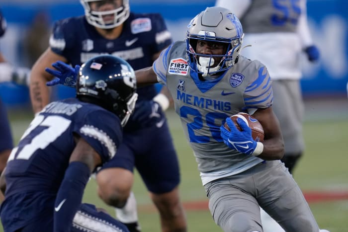 Dec 27, 2022; Dallas, Texas, USA; Memphis Tigers running back Asa Martin (28) runs the ball against Utah State Aggies safety Hunter Reynolds (27) during the second half in the 2022 First Responder Bowl at Gerald J. Ford Stadium.