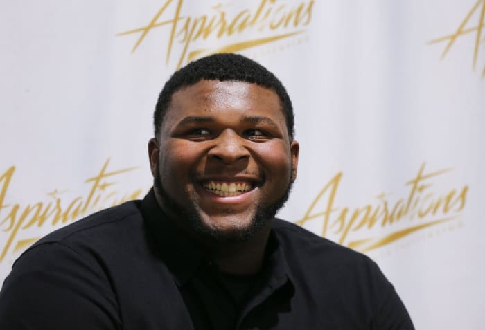 Five-star offensive tackle Kiyaunta Goodwin was all smiles after he made the decision to play football at Kentucky instead of Michigan State during a signing ceremony at the Aspirations gym in Louisville, Ky. on Dec. 15, 2021.
