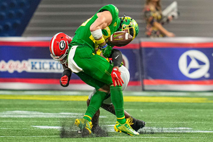 Sep 3, 2022; Atlanta, Georgia, USA; Oregon Ducks wide receiver Chase Cota (23) loses the ball after being hit by Georgia Bulldogs defensive back Christopher Smith (29) during the second half at Mercedes-Benz Stadium. Mandatory Credit: Dale Zanine-USA TODAY Sports