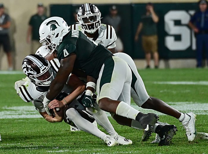 Sep 2, 2022; East Lansing, Michigan, USA; Michigan State Spartans linebacker Jacoby Windmon (4) sacks Western Michigan Broncos quarterback Jack Salopek (6) in the fourth quarter at Spartan Stadium during their game against Western Michigan University.