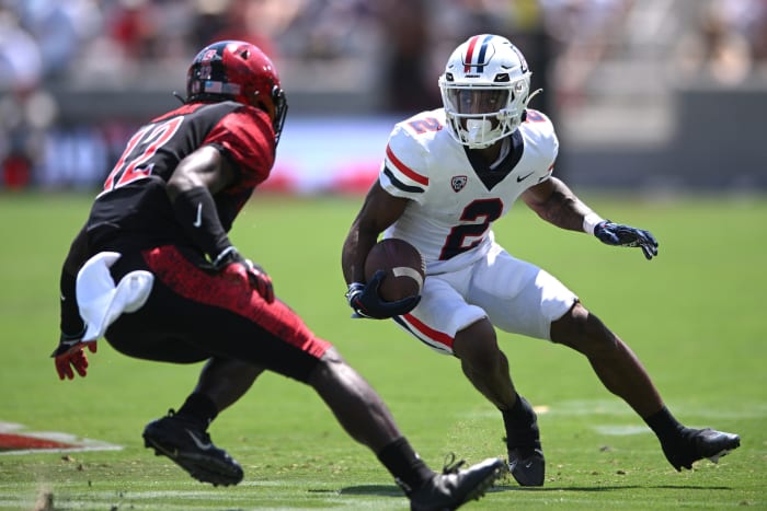 Sep 3, 2022; San Diego, California, USA; Arizona Wildcats wide receiver Jacob Cowing (2) runs with the ball while defended by San Diego State Aztecs cornerback Dallas Branch (12) during the first half at Snapdragon Stadium. Mandatory Credit: Orlando Ramirez-USA TODAY Sports