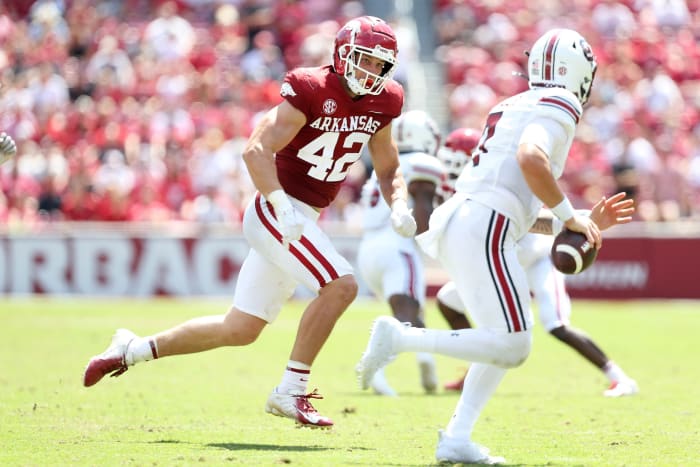 Sep 10, 2022; Fayetteville, Arkansas, USA; Arkansas Razorbacks linebacker Drew Sanders (42) pursues South Carolina Gamecocks quarterback Spencer Rattler (7) during the second half at Donald W. Reynolds Razorback Stadium. Arkansas won 44-30.