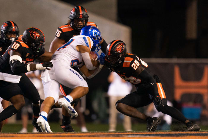CORVALLIS, OR - SEPTEMBER 03: Boise State Broncos running back George Holani (24) gets tackled by Oregon State Beavers defensive back Kitan Oladapo (28), linebacker Andrew Chatfield Jr. (10), and defensive lineman Thomas Sio (76) at Reser Stadium on September 3, 2022 in Corvallis, Oregon.
