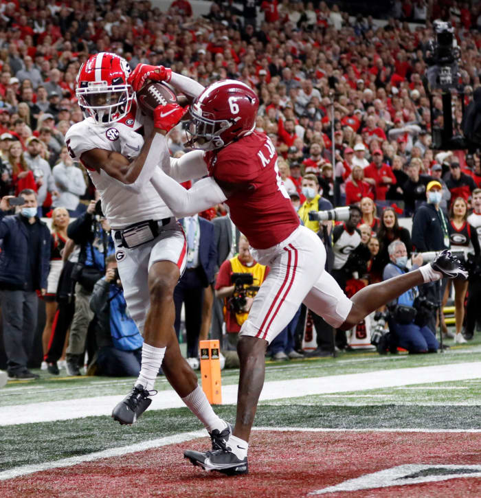 Georgia wide receiver Adonai Mitchell brings down a touchdown catch while being defended by Alabama's Khyree Jackson on Monday night at Lucas Oil Stadium in Indianapolis.
