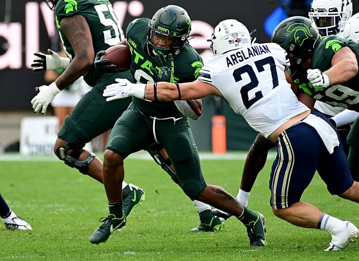 Sep 10, 2022; East Lansing, Michigan, USA; Michigan State Spartans running back Jalen Berger (8) evades Akron Zips linebacker Bubba Arslanian (27) for a first down.