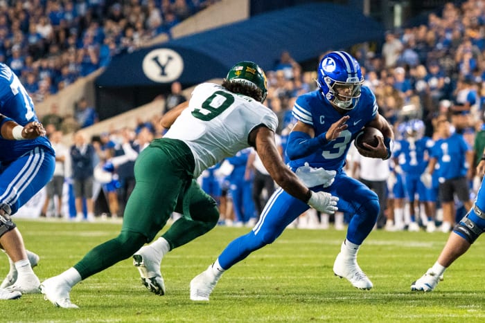 Sep 10, 2022; Provo, Utah, USA; Brigham Young Cougars quarterback Jaren Hall (3) runs the ball against Baylor Bears defensive lineman TJ Franklin (9) during the first half at LaVell Edwards Stadium.