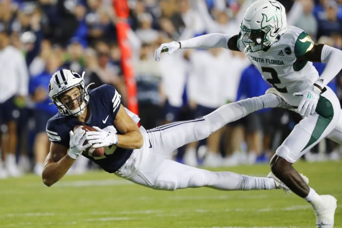 Sep 25, 2021; Provo, Utah, USA; Brigham Young Cougars wide receiver Gunner Romney (18) makes a reception for a first down past South Florida Bulls defensive back TJ Robinson (2) in the first quarter at LaVell Edwards Stadium.