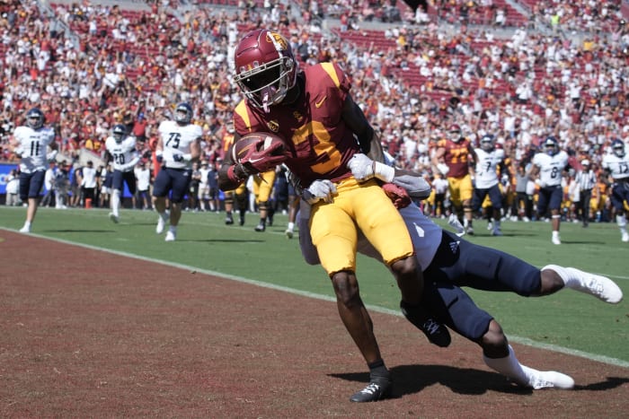 Sep 3, 2022; Los Angeles, California, USA; Southern California Trojans wide receiver Jordan Addison (3) scores a touchdown as Rice Owls cornerback Sean Fresch (1) defends in the first quarter at United Airlines Field at Los Angeles Memorial Coliseum.