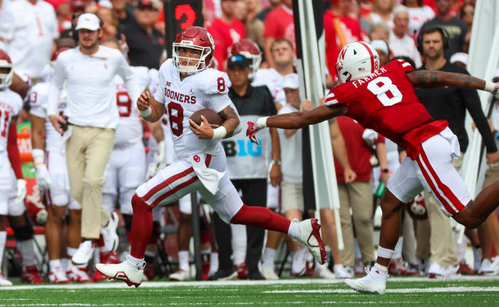 Sep 17, 2022; Lincoln, Nebraska, USA; Oklahoma Sooners quarterback Dillon Gabriel (8) runs for a touchdown past Nebraska Cornhuskers defensive back Myles Farmer (8) during the first quarter at Memorial Stadium.