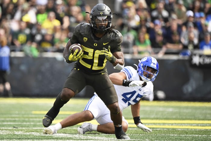 Sep 17, 2022; Eugene, Oregon, USA; Oregon Ducks running back Jordan James (20) breaks away from Brigham Young Cougars defensive lineman Pepe Tanuvasa (45) during the first half for a first down at Autzen Stadium.