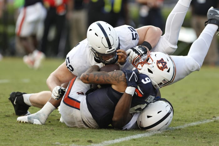 Sep 17, 2022; Auburn, Alabama, USA; Auburn Tigers quarterback Robby Ashford (9) is tackled by Penn State Nittany Lions defensive end Dani Dennis-Sutton (33) and defensive tackle Jordan van den Berg (52) during the fourth quarter at Jordan-Hare Stadium.