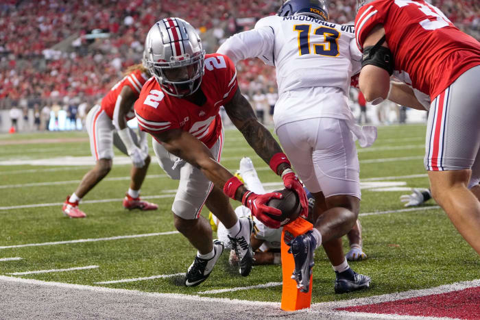 Sep 17, 2022; Columbus, Ohio, USA; Ohio State Buckeyes wide receiver Emeka Egbuka (2) scores a touchdown around Toledo Rockets cornerback Chris McDonald (13) during the first half of the NCAA Division I football game at Ohio Stadium.
