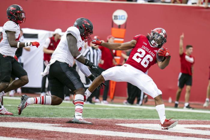 Sep 17, 2022; Bloomington, Indiana, USA; Indiana Hoosiers running back Josh Henderson (26) catches the ball for a touchdown in front of Western Kentucky Hilltoppers linebacker JaQues Evans (3) during the second half at Memorial Stadium. Hoosiers won 33 to 30 in overtime.