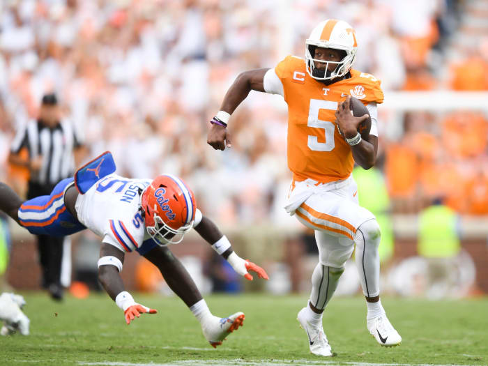 Tennessee quarterback Hendon Hooker (5) runs past Florida safety Kamari Wilson (5) during an NCAA college football game on Saturday, September 24, 2022 in Knoxville, Tenn.