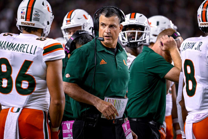 Sep 17, 2022; College Station, Texas, USA; Miami Hurricanes head coach Mario Cristobal talks with this team during a timeout during the second half of the game between the Texas A&M Aggies and the Miami Hurricanes at Kyle Field.