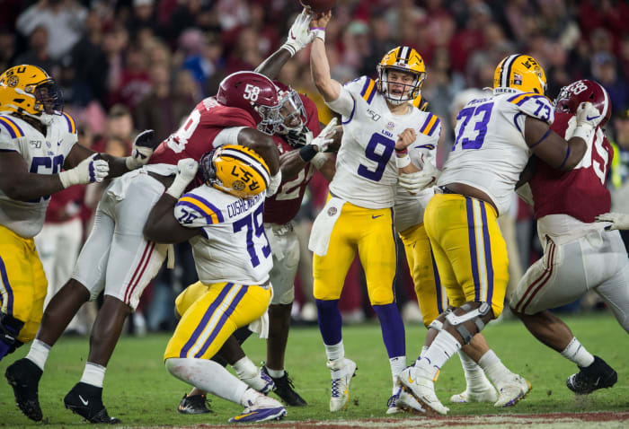 LSU quarterback Joe Burrow (9) throws the ball under pressure from Alabama defensive lineman Christian Barmore (58) at Bryant-Denny Stadium in Tuscaloosa, Ala., on Saturday, Nov. 9, 2019. LSU defeated Alabama 46-41.