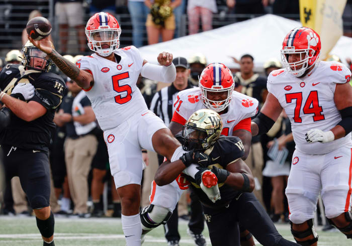 Sep 24, 2022; Winston-Salem, North Carolina, USA; Clemson Tigers quarterback DJ Uiagalelei (5) passes the ball under pressure from Wake Forest Demon Deacons defensive lineman Jasheen Davis (30) during the second half at Truist Field.