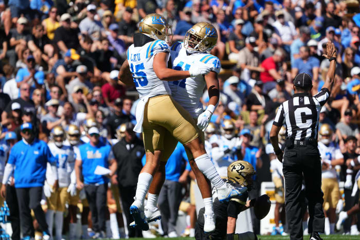 Sep 24, 2022; Boulder, Colorado, USA; UCLA Bruins linebacker Laiatu Latu (15) and linebacker Devin Aupiu (41) celebrate a play in the first quarter against the Colorado Buffaloes at Folsom Field.