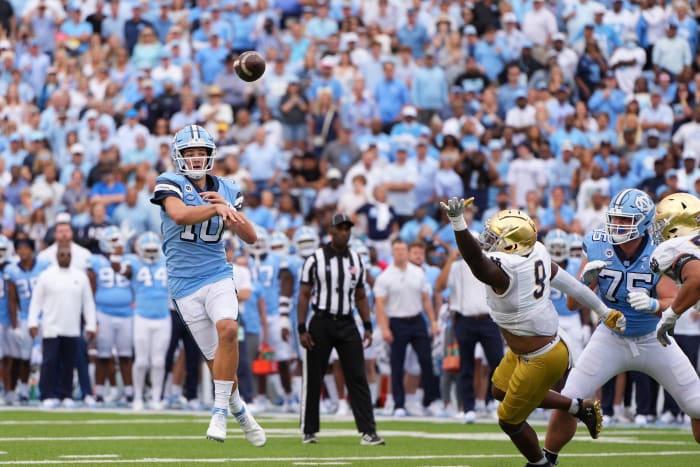 Sep 24, 2022; Chapel Hill, North Carolina, USA; North Carolina Tar Heels quarterback Drake Maye (10) throws a touchdown pass as Notre Dame Fighting Irish defensive lineman Justin Ademilola (9) defends in the second quarter at Kenan Memorial Stadium.