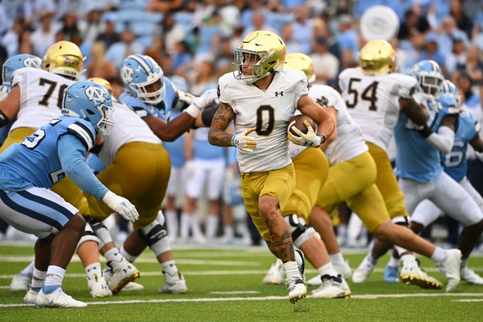 Sep 24, 2022; Chapel Hill, North Carolina, USA; Notre Dame Fighting Irish wide receiver Braden Lenzy (0) with the ball as North Carolina Tar Heels defensive lineman Kaimon Rucker (25) defends in the third quarter at Kenan Memorial Stadium.