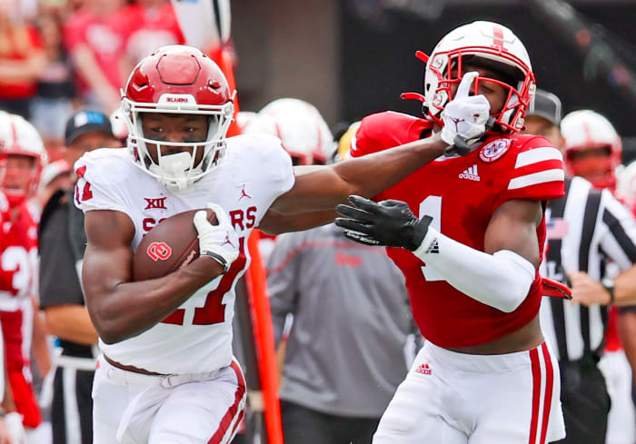 Sep 17, 2022; Lincoln, Nebraska, USA; Oklahoma Sooners wide receiver Marvin Mims (17) stiff arms Nebraska Cornhuskers defensive back Marques Buford Jr. (1) during the first half at Memorial Stadium.