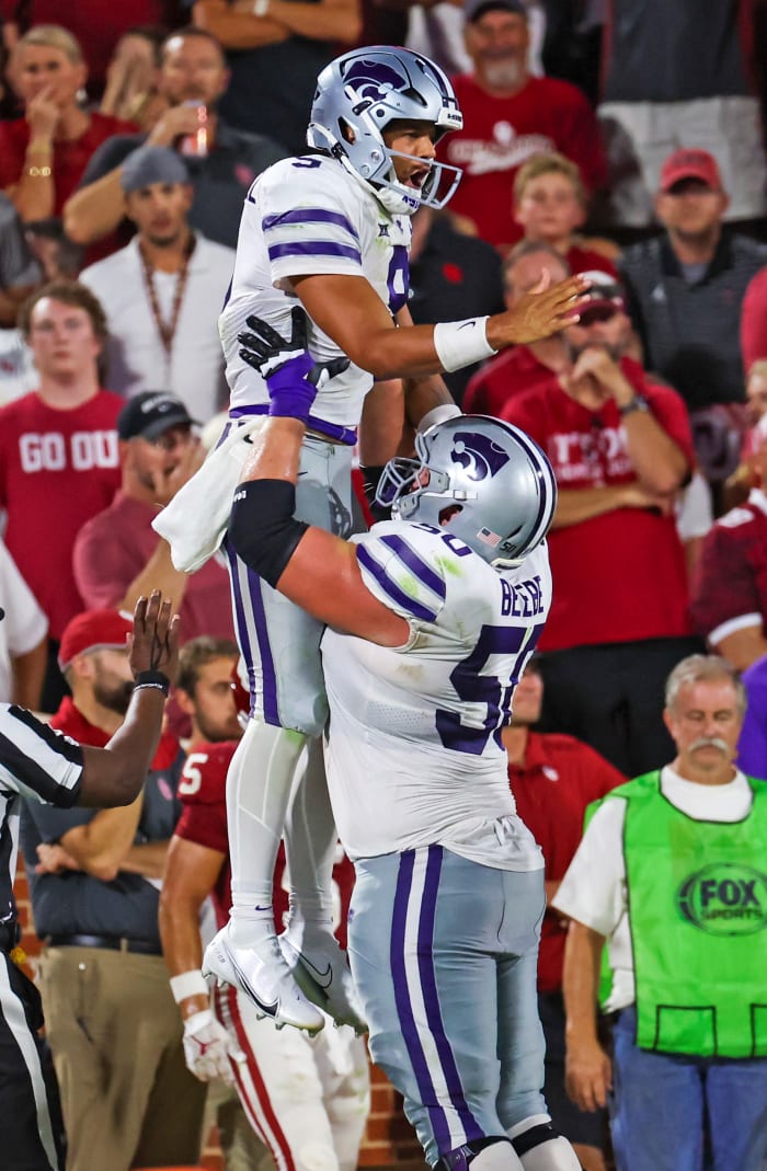 Sep 24, 2022; Norman, Oklahoma, USA; Kansas State Wildcats quarterback Adrian Martinez (9) celebrates with offensive lineman Cooper Beebe (50) after scoring a touchdown during the second half against the Oklahoma Sooners at Gaylord Family-Oklahoma Memorial Stadium.