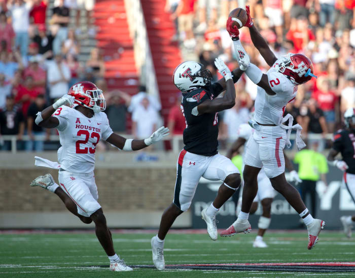 Houston's defensive back Gervarrius Owens (2), far right, intercepts the ball against Houston, Saturday, Sept. 10, 2022, at Jones AT&T Stadium.