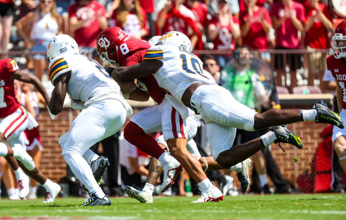 Sep 3, 2022; Norman, Oklahoma, USA; Oklahoma Sooners quarterback Dillon Gabriel (8) is tackled by UTEP Miners linebacker Tyrice Knight (10) during the first half at Gaylord Family-Oklahoma Memorial Stadium.